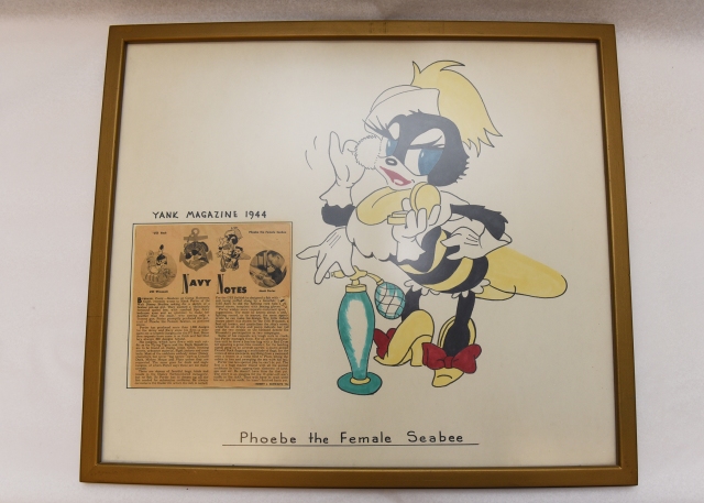 Framed artwork of “Phoebe the Female Seabee” by Disney artist Hank Porter and 1944 article from Yank Magazine. (U.S. Navy Museum Collection)