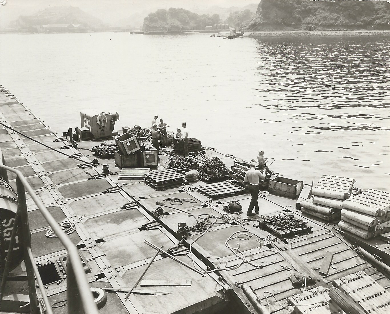 Seabees working on a Rhino Ferry near pontoon causeway, Inchon, circa 1950.