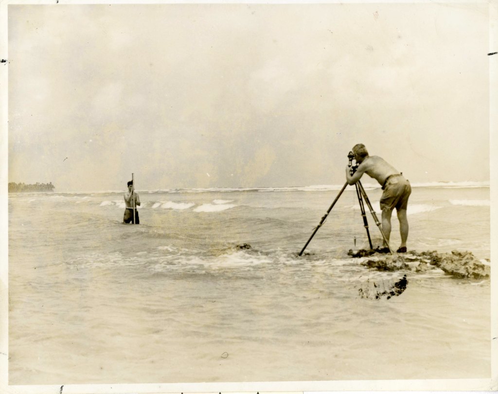 Seabee surveying a beach, Gilbert Islands.